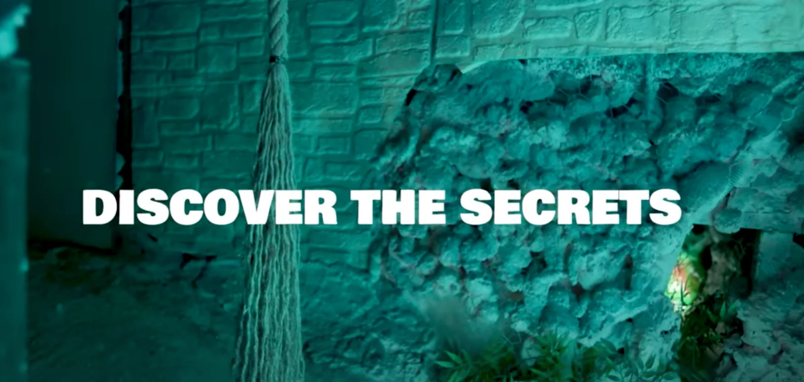 Atmospheric still of The Jungle escape room, with dramatic turquoise jungle scenery and the words Discover the Secrets
